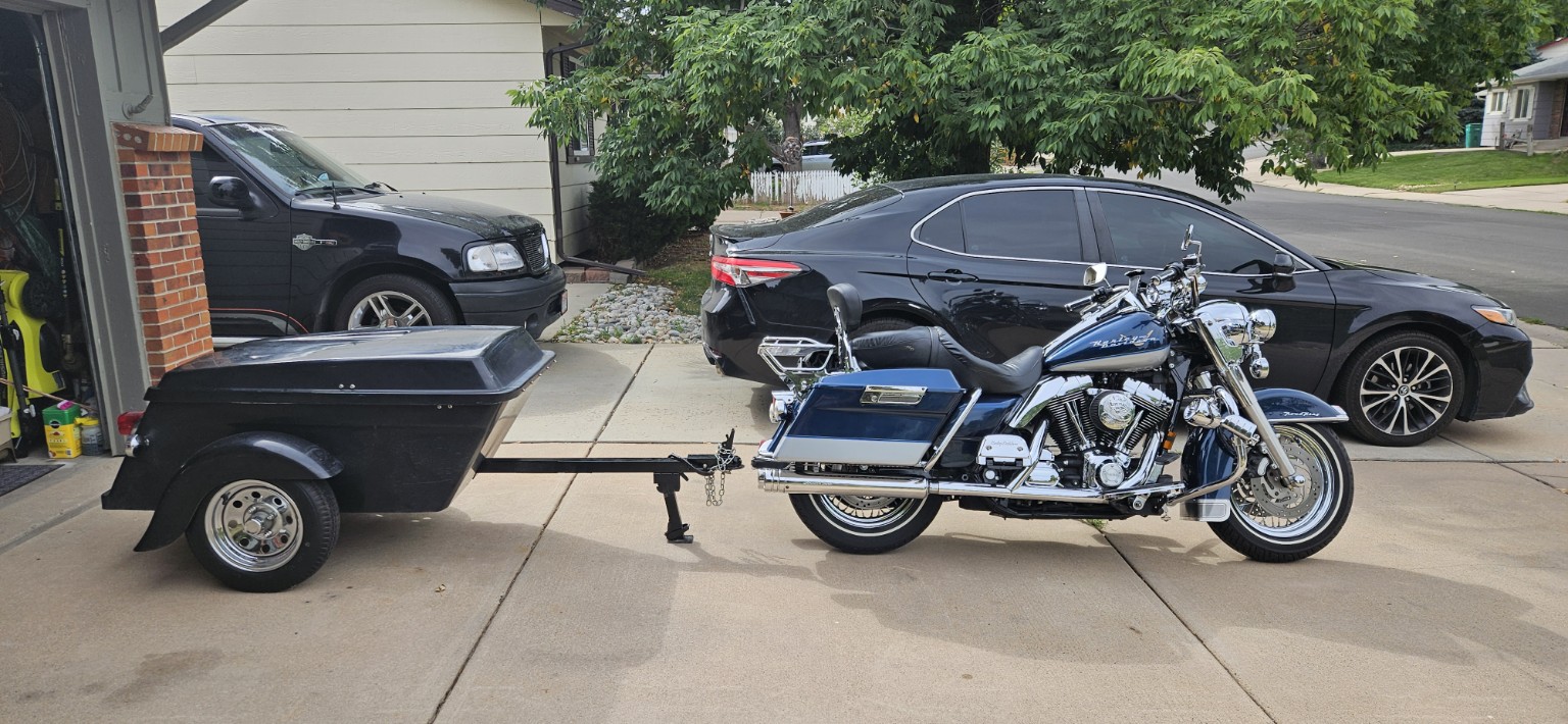 Harley-Davidson Road King towing a small cargo trailer